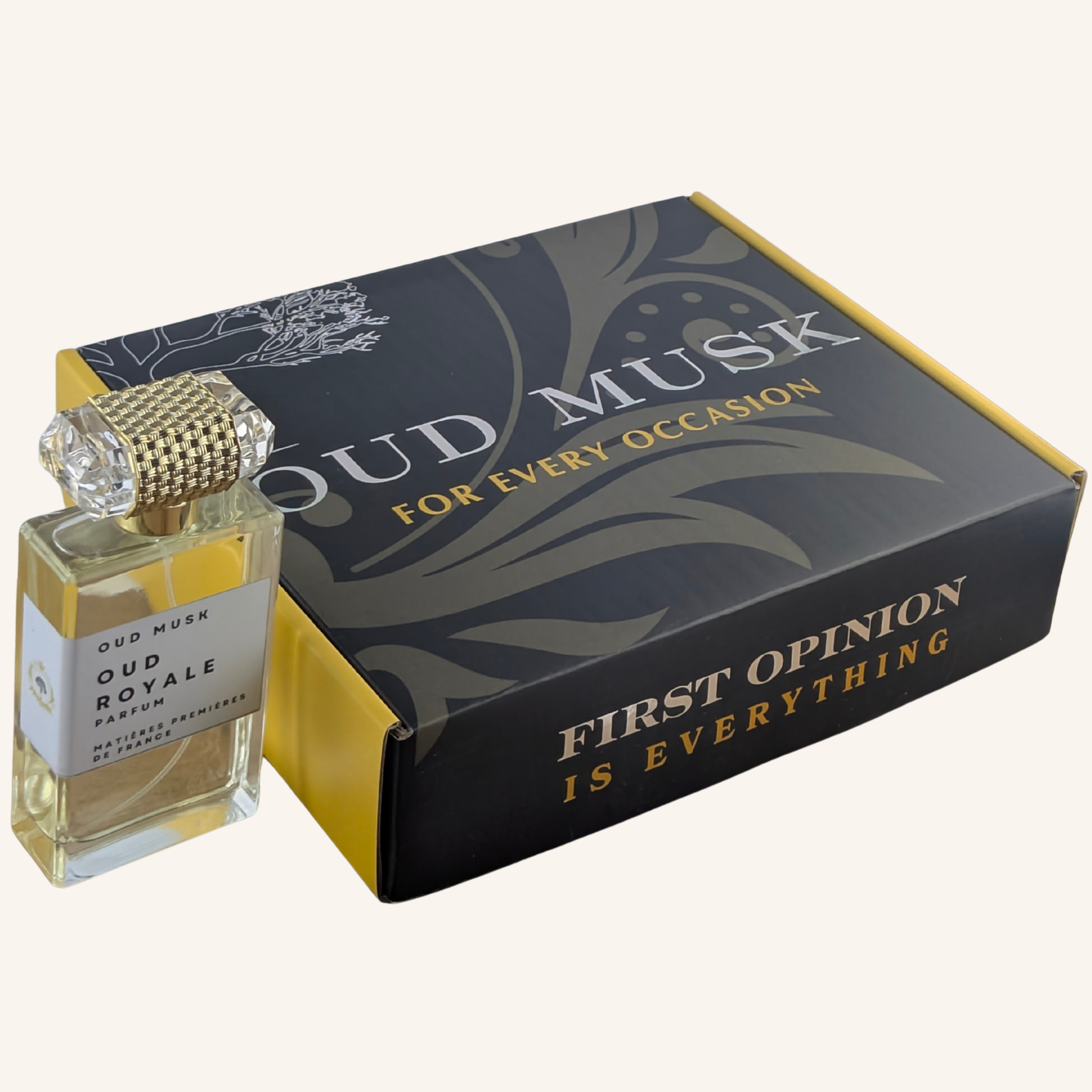 Perfume bottle and packaging with 'Oud Musk' branding on a white background